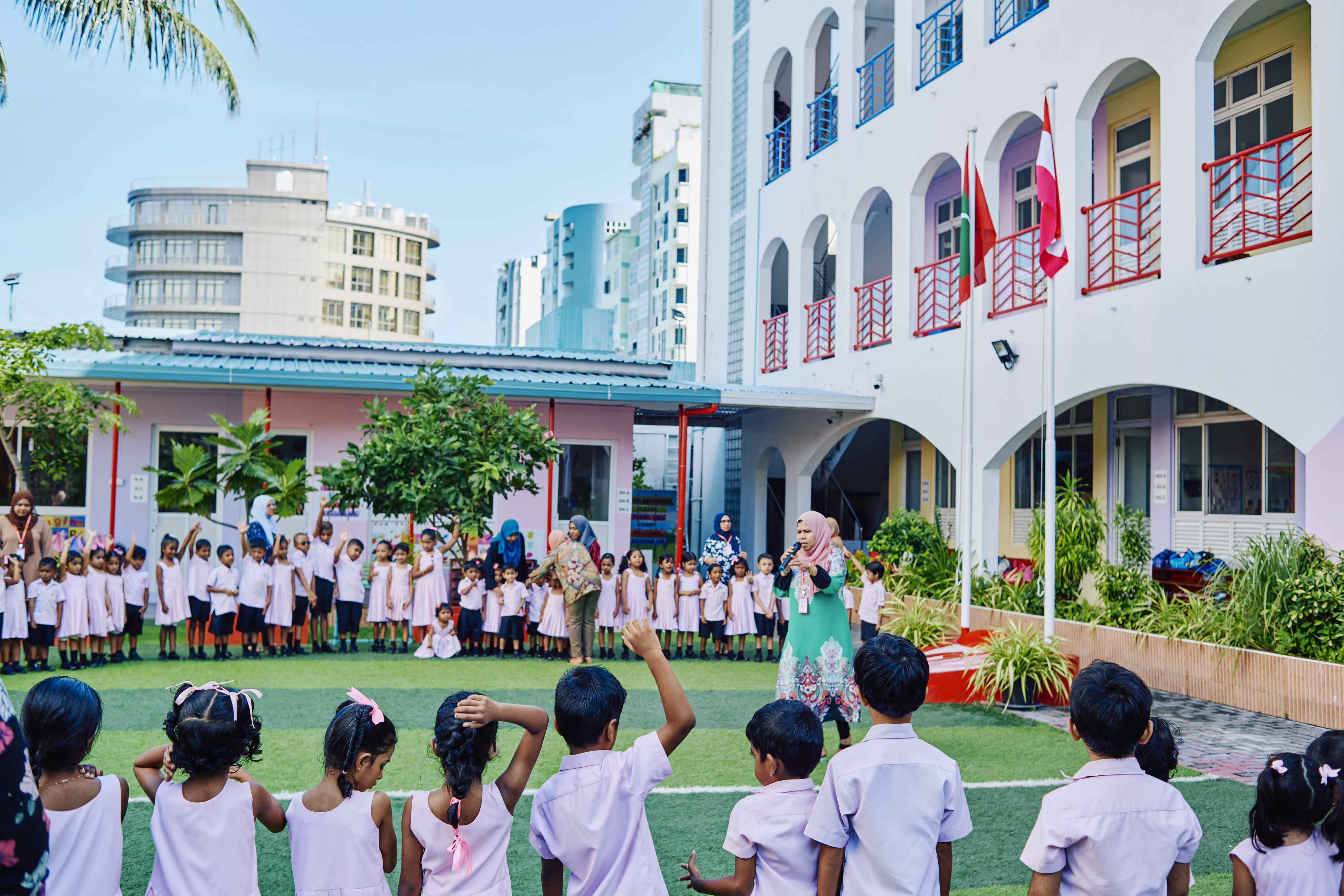 Children and teachers gathered in the school courtyard